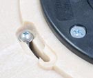 Adjustment screws raise glide plate as bristles wear